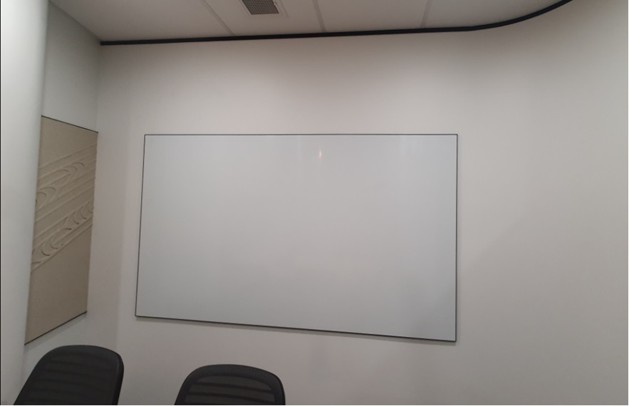 Porcelain whiteboard mounted on an office wall